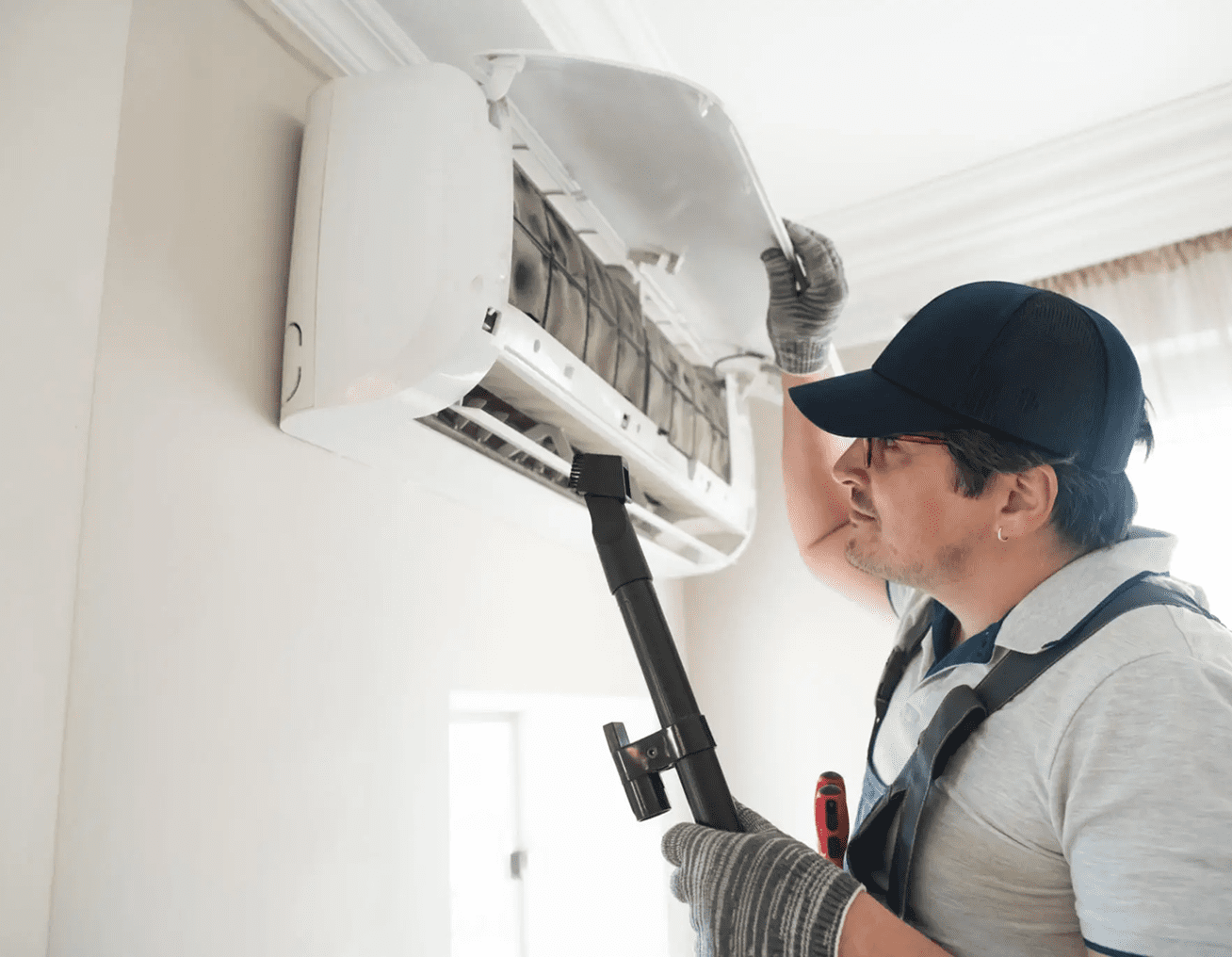 Worker maintaining air conditioning system