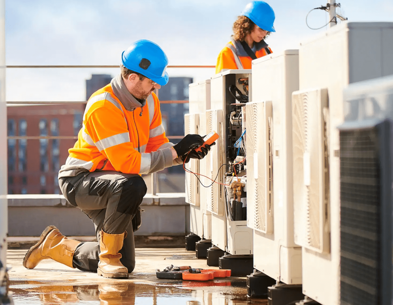 Engineers in safety gear on rooftop