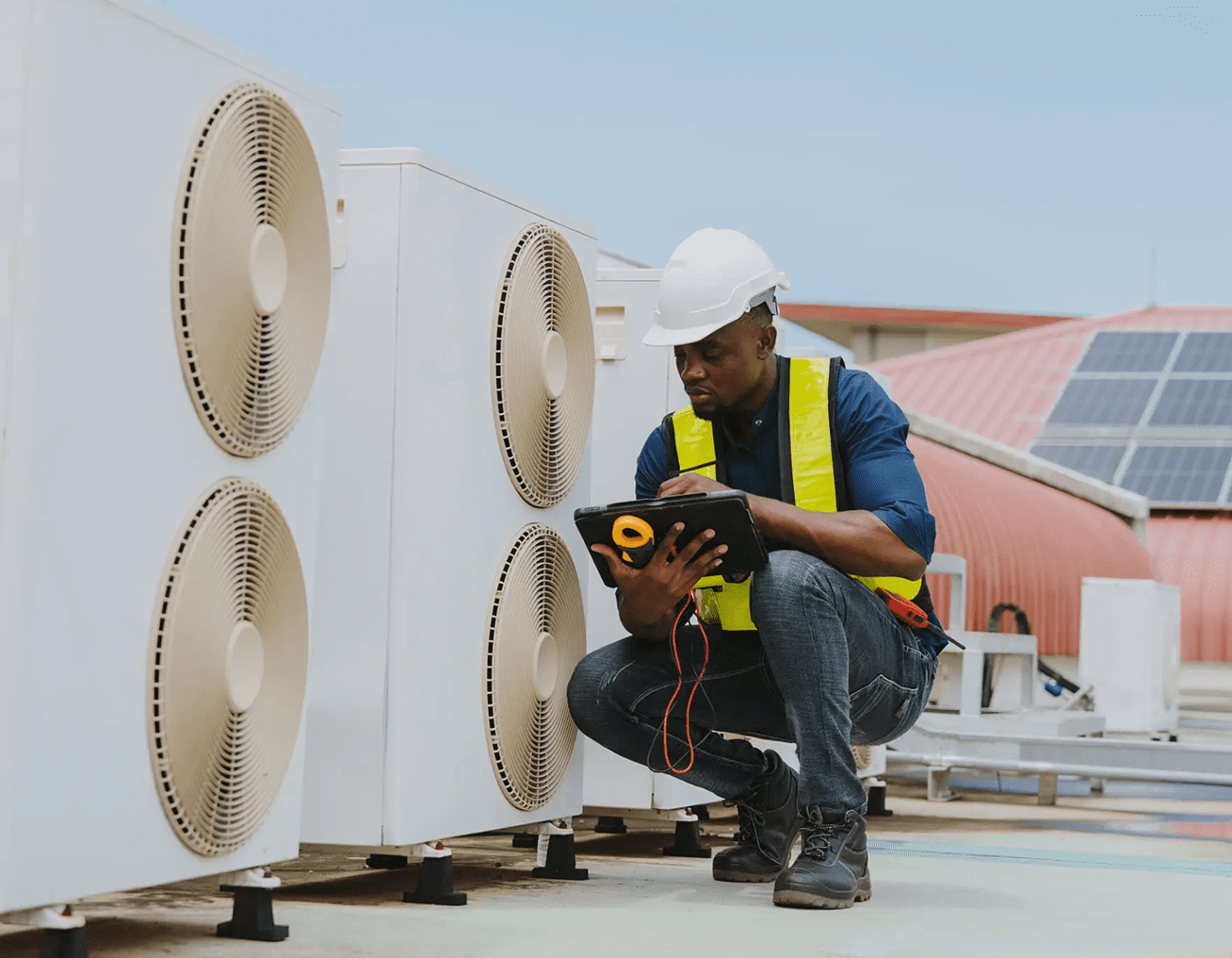 Engineer examining air conditioning equipment outdoors